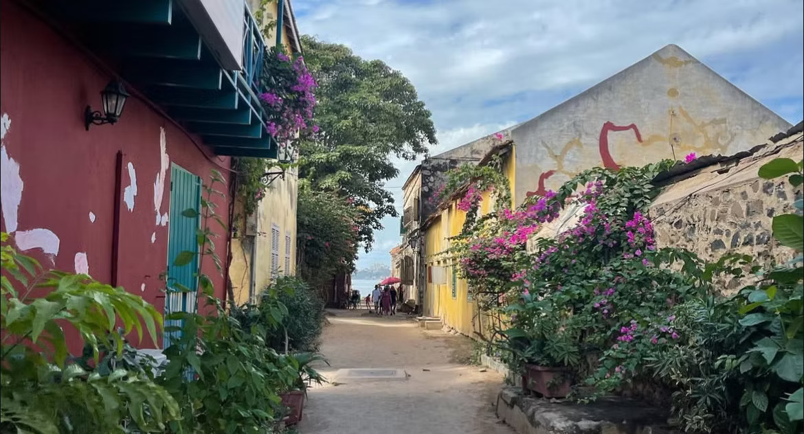 A colorful street on Gorée Island, Dakar — bougainvillea and colonial architecture in Senegal